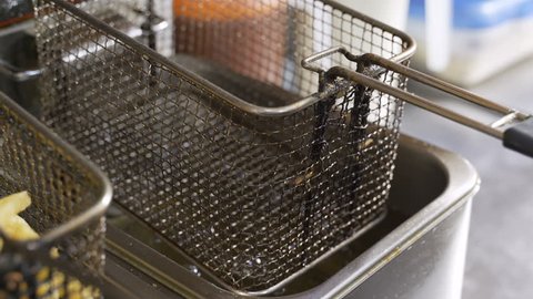 The preparation of french fries in the fryer in the restaurant