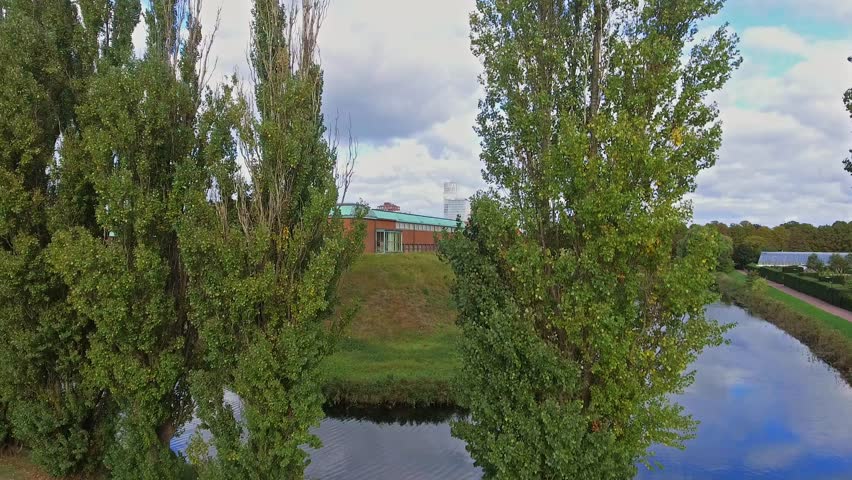 Aerial dolly shot of Malmö and Malmoe Museum with the city and Malmo Live in the distance in 4k.