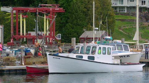 ROCKPORT, MAINE circa July 2017 - Lobster fishing boat unloading it??s daily catch at a quaint New England harbor in Lockport