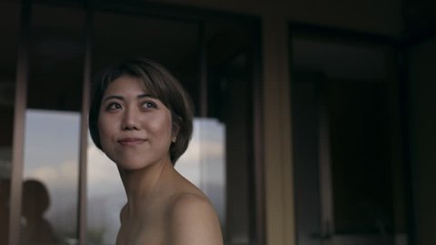 Happy Japanese woman meeting her friend in a traditional spa with soft natural lighting. Medium shot on 4k RED camera.