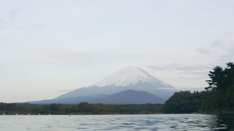 View of Mount Fuji in the distance over the water with soft natural lighting. Wide shot on 4k RED camera.