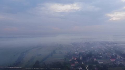 Atmospheric pollution. Burning weeds on the field, smoke, damage to environment. Autumn time, rural area. Aerial view from drone