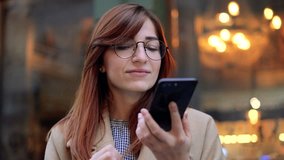 Woman using a smart phone voice recognition function online walking on a city street, talking to mobile assistant. Girl using smart phone voice recognition, dictates thoughts, voice dialing message - Powered by Shutterstock - Get 15% off with code: PIKWIZARD15