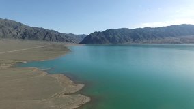 Aerial video of a blue lake in the mountains. Kazakhstan. Lake Bortagoy.