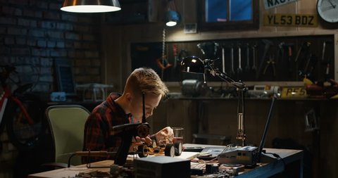 Slow motion shot of a boy repairing a toy car