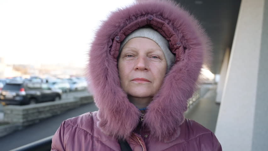 Beautiful middle-aged woman outdoors. Selective focus.