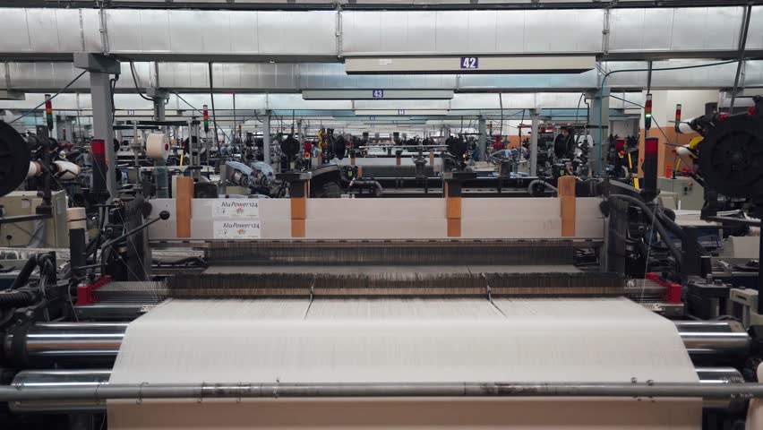 BELARUS, MINSK - DECEMBER 7, 2018: Spinning factory, production of fabrics, thread of silk, linen, and synthetics, spinning machine at work on light industry. | Shutterstock HD Video #1020808867
