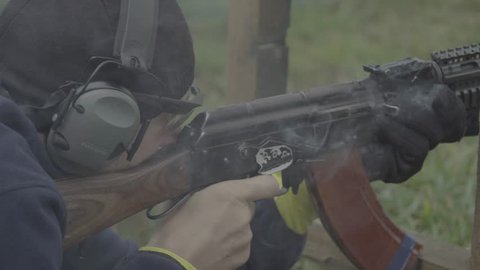 KYIV, UKRAINE - SEPTEMBER 12, 2018. A man shooter shoots a rifle. Close-up.
