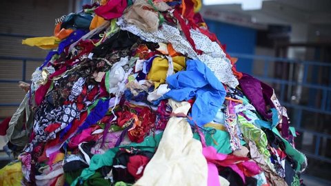A pile of waste clothes thrown in trash, it could be used in recycling and given to poor
