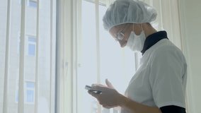 Male surgeon holding smartphone - Powered by Shutterstock - Get 15% off with code: PIKWIZARD15