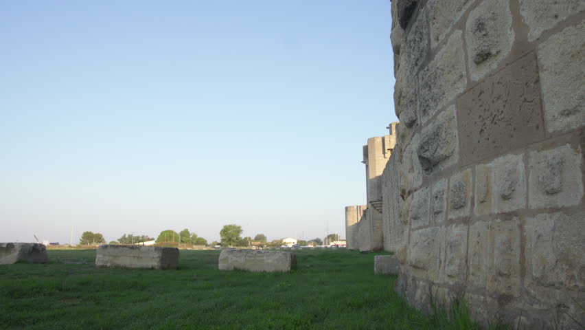 Fortress town of Aigues Mortes in southern France - panning shot (slide) of outer walls and gate