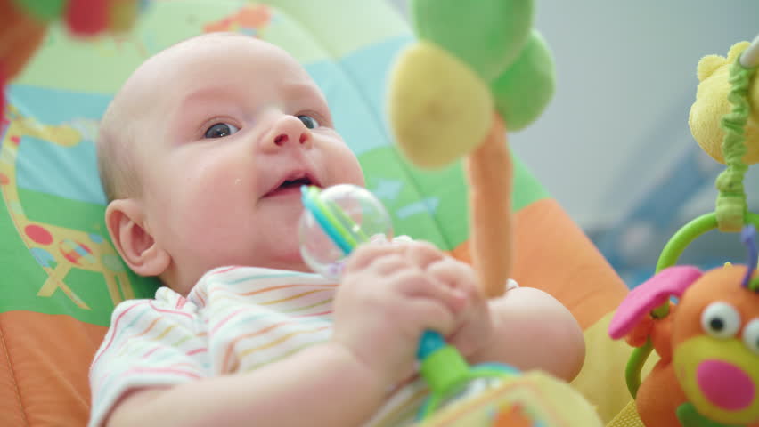 baby playing with rattle