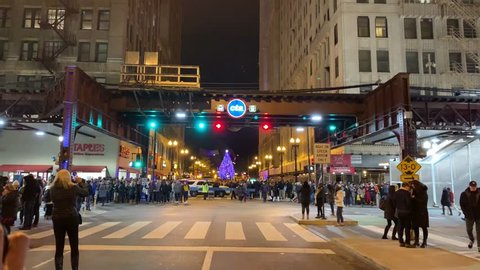 Chicago, IL / USA - November 16 2018: Lighting of the Millennium Park Christmas tree in downtown Chicago, on Washington and Wabash, with a nightly CTA train passing by.