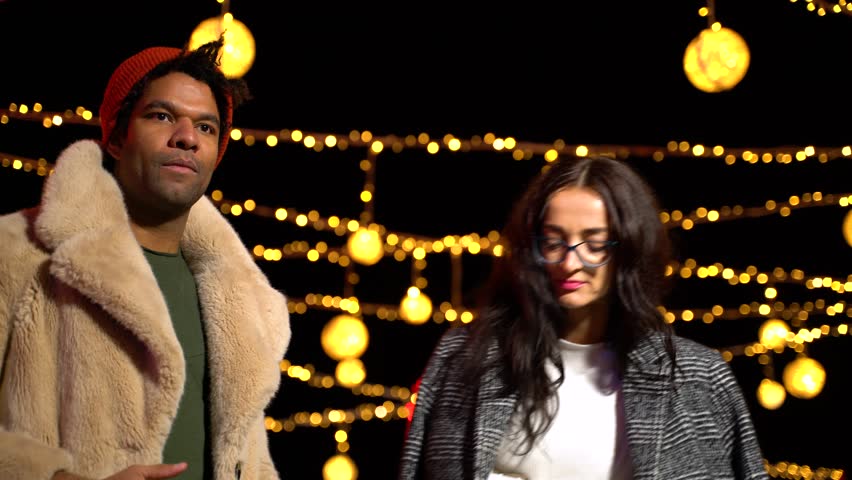 Couple posing for funny photo at Christmas market, Zagreb, Croatia.