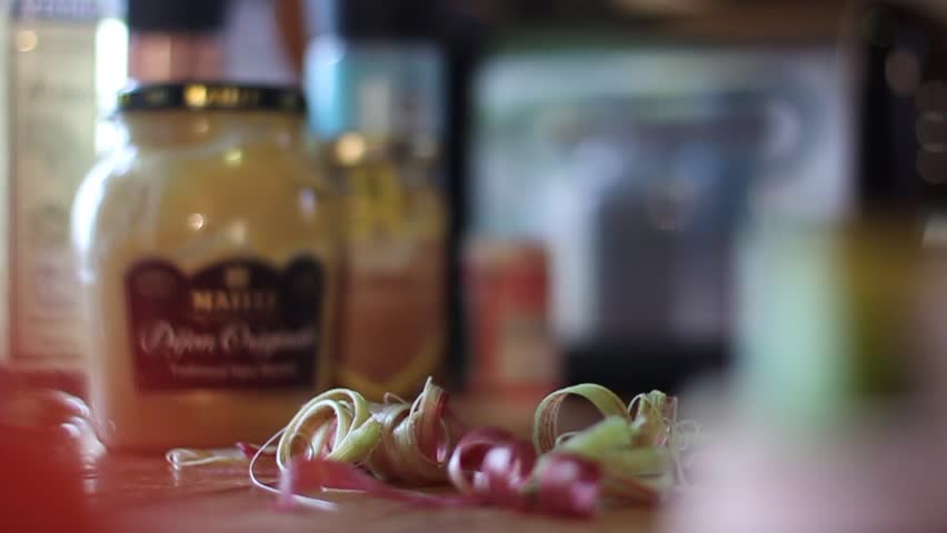 Close up of hand peeling leek with knife in the farm.