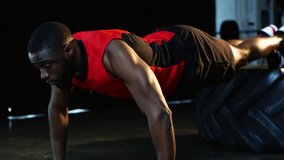 african american sportsman doing push ups at gym in slow motion