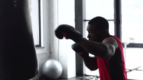 young african american boxer training at gym in slow motion