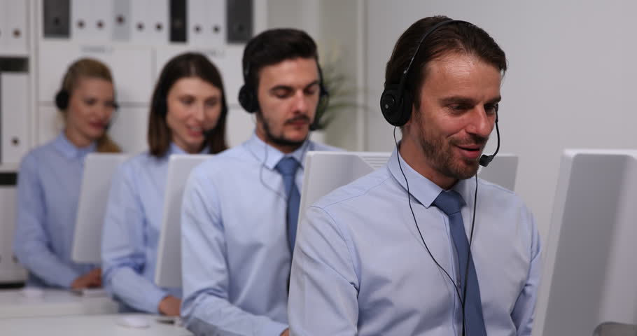Portrait of Smiling Call Center Agents Group of Dispatchers Talking on Headsets Royalty-Free Stock Footage #1020877621