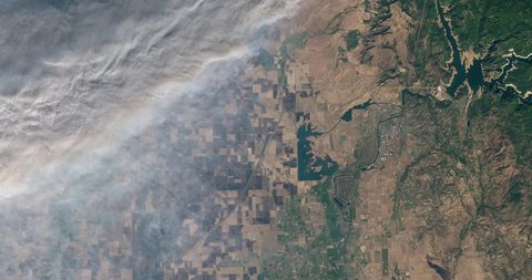 Very high-altitude overflight aerial of thick smoke from the Camp Fire, California. Clip loops and is reversible. Elements of this image furnished by NASA