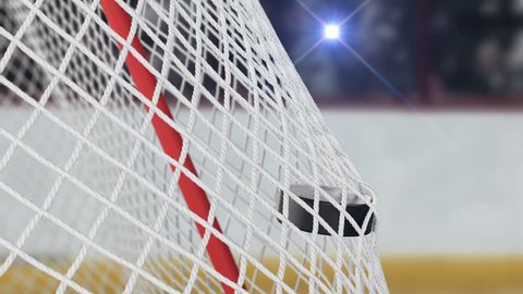 Hockey Puck Flying into Gates Net in Slow Motion with Bright Camera Flashes. Close-up Goal Moment. Beautiful 3d animation Sport Concept. 4k Ultra HD 3840x2160.