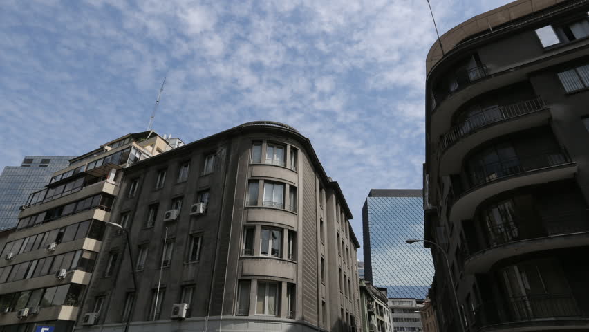 A time lapse sequence of clouds rolling across the sky above high-rise buildings in downtown Santiago, Chile