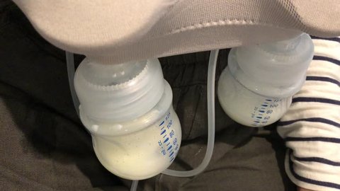 Asian women are using breast pump milk automatic for the son baby.
