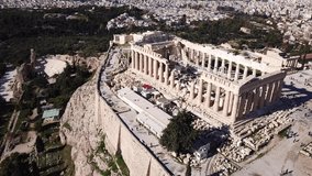 Aerial drone video of iconic masterpiece, the Parthenon, on top of Acropolis hill, Athens, Greece