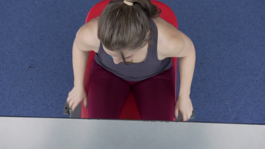Close-up - Fit Young Woman Training Legs Muscles on Simulator Machine. Training at the Gym, Fitness, Sports and Active Lifestyle. Strength Training
