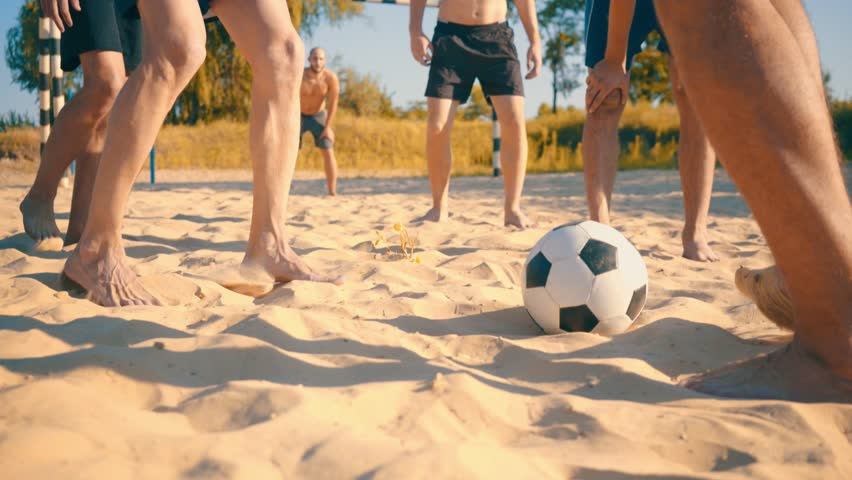 Sport Soccer players in dynamic action funny play on the sand in beach football in summer sunny day under sunlight. 
 Royalty-Free Stock Footage #1020894145