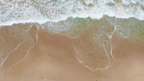 An aerial view of waves breaking onto the sand at City Beach in Perth, Western Australia.