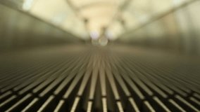 Defocused the escalator moving sidewalk at the airport, woman passenger leg with sport shoe or sneaker walk through the video camera/ traveling alone concept, Full HD footage