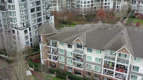 Apartment buildings in suburb at Fall. Luxury houses with nice landscape. Aerial drone view.