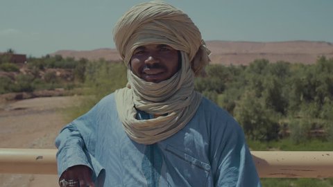 Marrakesh, Morocco - 03 27 2017: Moroccan man smile on camera with desert in background