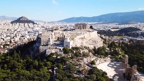 Aerial drone video of iconic Acropolis hill Propylaia and the Parthenon a masterpiece of ancient world, Athens historic center, Attica, Greece