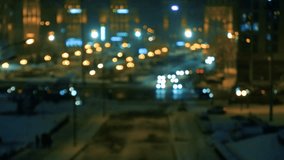 Traffic car lights on the night city street. Video of blurred car and night city lights. Winter snowy city scene