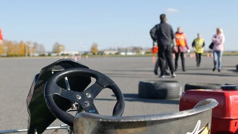 BOBRUISK, BELARUS - OCTOBER 21, 2018: Karting competitions among young men, judges and racers go for a break, slow mo