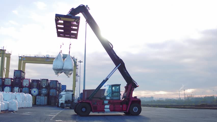 Crane operator and Mobile crane machine stand by waiting for lifting white bags in the dock. Royalty-Free Stock Footage #1020927799