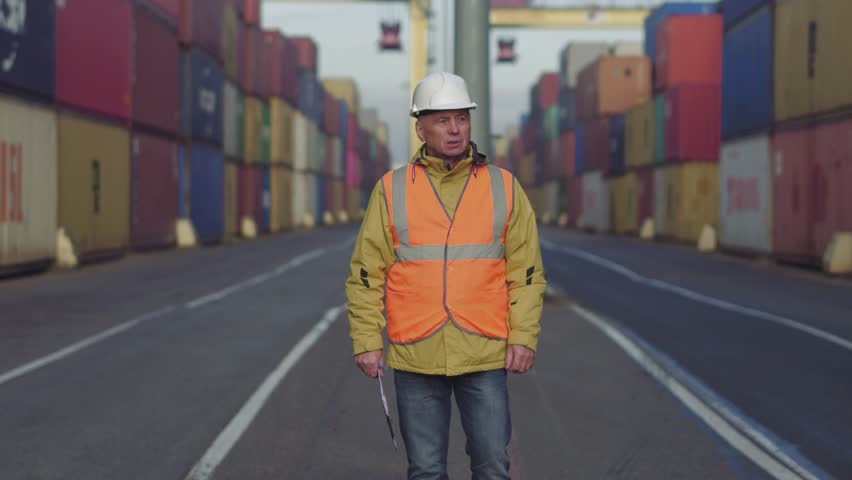 Caucasian 50s years old man making notes while checking terminal cargo dock. Royalty-Free Stock Footage #1020927826