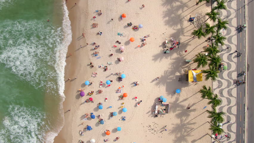 Rio de Janeiro, Brazil, top down aerial view of waves breaking on the shore of famous Copacabana beach during summer.  Royalty-Free Stock Footage #1020930103