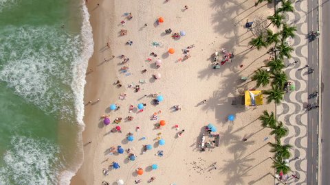 Rio de Janeiro, Brazil, top down aerial view of waves breaking on the shore of famous Copacabana beach during summer. 