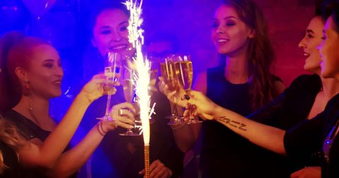 Girls are celebrating their Friend's Birthday. They are happy and cheerful. They have glasses of champagne in their hands