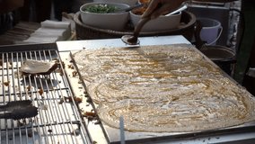 Women are making Thai Crispy Pancake (Khanom bueang). famous sweet street food at Bangkok market in Thailand. 4K video footage
