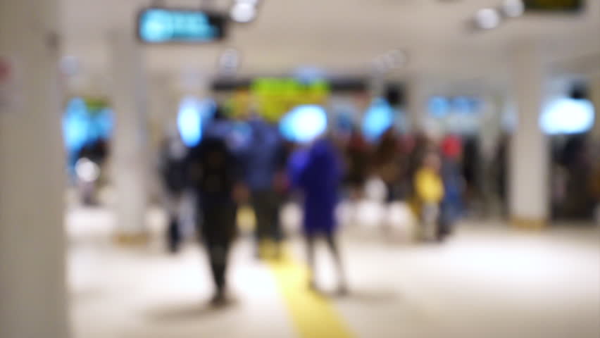 People walking in hall background. Pedestrians walking in shopping mall. Out of focus background from busy in department store with people. Sapporo, Japan.