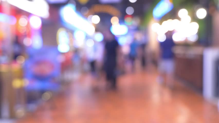 defocused crowd of walking people in the shopping mall center