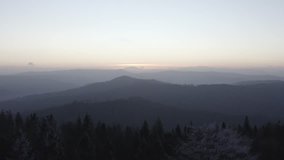 Forest and mountains silhouettes in sunset, 4k aerial drone footage ungraded raw/flat