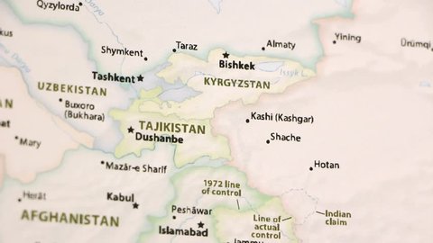 Tajikistan and Kyrgyzstan on a political map of the world. Video defocuses showing and hiding the map.