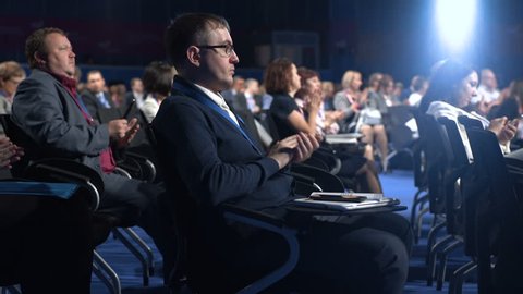 Novosibirsk Russia - 29 August 2018: Work of successful economic show in crowded room or company center. Listeners view convention forum on row of chair seat. Education occupation of executive manager