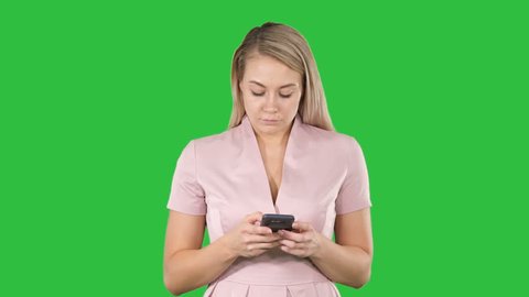 Blonde girl holding mobile phone Young woman, cellphone addiction, online dating app, communication, new technologies, trendy concepts on a Green Screen, Chroma Key.