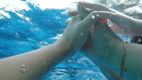 Holding hand in the pool 