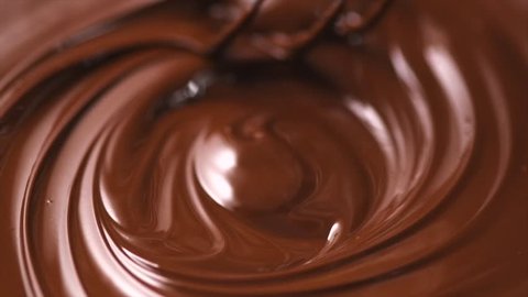 Chocolate. Mixing melted liquid premium dark chocolate with a whisk. Close up of liquid hot chocolate swirl. Confectionery. Confectioner prepares dessert, sauce. 4K UHD video, slow motion 120 fps